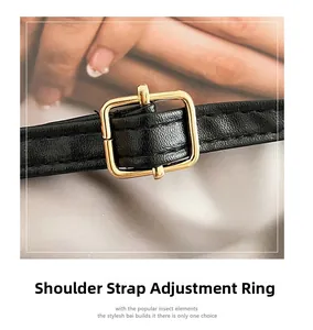 Detail of black lychee grain leather shoulder strap with golden adjustable metal buckle