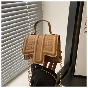 Chic brown faux leather mini crossbody bag with crocodile texture and gold chain strap
