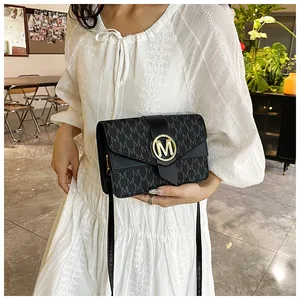 Detail of grey crossbody bag with black letter print and golden metal M buckle