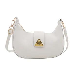 Minimalist white leather crescent underarm bag with elegant gold triangle buckle closure