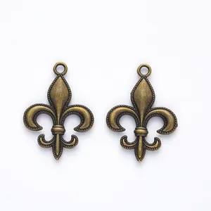 Vintage bronze fleur-de-lis metal charms for DIY jewelry making with relief texture