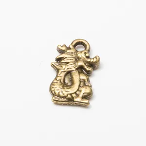 Macro shot of antique bronze dragon pendant with detailed texture for DIY jewelry making