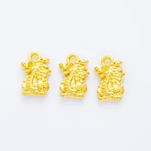 Detailed view of three golden dragon pendants with matte sand gold finish for DIY jewelry
