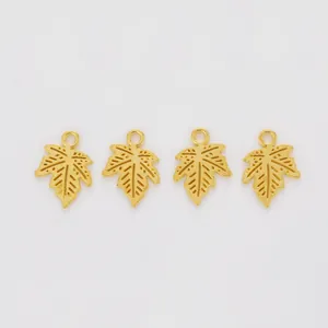 Detailed view of four golden maple leaf charms with intricate veins for DIY jewelry