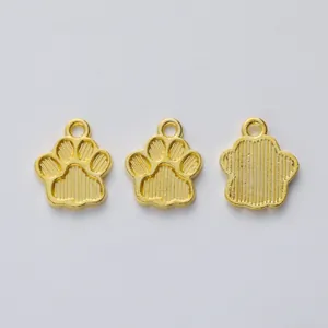 Three gold zinc alloy bear paw pendants for DIY jewelry making on white background