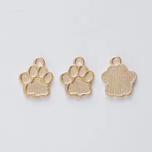 Detailed view of three gold alloy bear paw pendants with textured backs for DIY jewelry