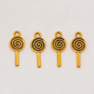 Close-up of four golden lollipop alloy pendants for DIY jewelry making accessories
