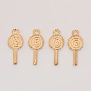 Close-up of four golden spiral lollipop charms made of vintage alloy for DIY jewelry