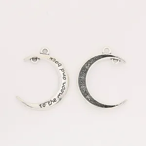 Antique silver crescent moon pendant with engraved text to the moon and back