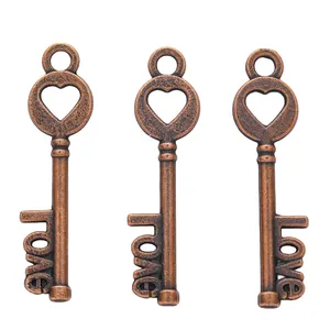 Detailed macro view of three vintage bronze heart-shaped keys featuring love word design