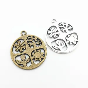 Vintage alloy round pendants with tree and snowflake cutouts in bronze and silver finishes