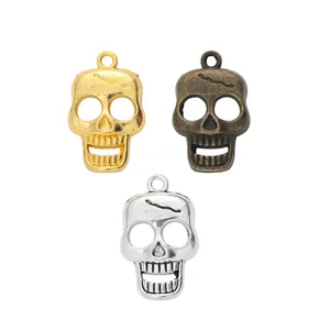 Three skull pendants in gold, bronze, and silver finishes for DIY jewelry making