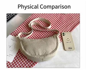 Beige nylon crescent bag with adjustable strap shown next to a smartphone for size reference