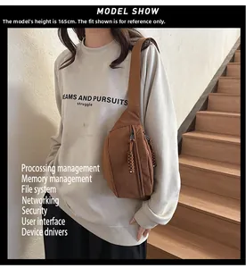 Close-up of brown corduroy crossbody bag with woven zipper pull details on a model