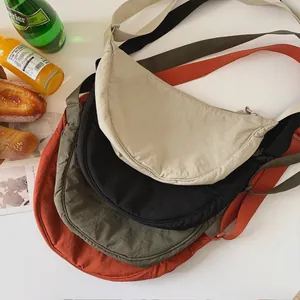 Lightweight nylon crescent crossbody bags in beige, black, green, and orange colors