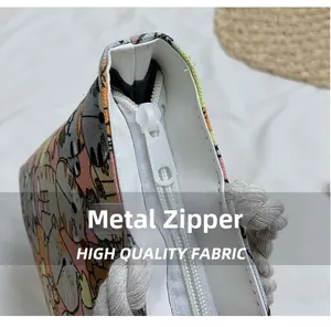 Detail of durable metal zipper and rope handle on canvas bag with cat print