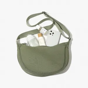 Lightweight avocado green nylon crossbody crescent bag showing large storage capacity