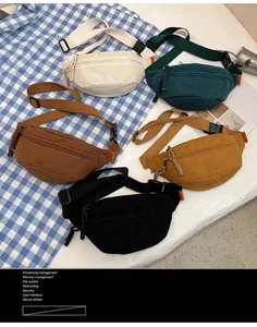 Detail of colorful corduroy waist bags with adjustable straps and woven zip pulls