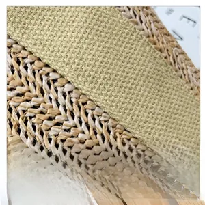 Detail of woven straw texture and durable olive green fabric strap with sewing craft
