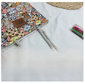 Detail of canvas tote bag featuring cat patterns and durable braided rope handles