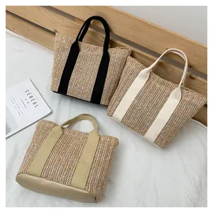 Close-up of three-piece woven straw tote bags in black, beige, and khaki colors