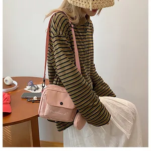 Pink nylon crossbody bag with white Dachshund embroidery and matching round coin pouch