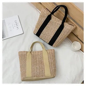 Detail view of woven straw tote bags with fabric handles in a minimalist lifestyle setting
