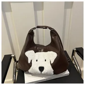 Detail of dark brown PU leather tote bag with white plush dog patch and zipper