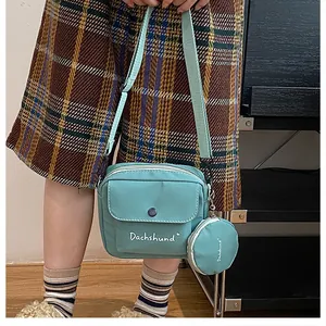 Detail of mint green crossbody bag set with dachshund print and small round coin purse