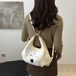 Minimalist beige shoulder bag featuring a plush puppy head design with adjustable strap