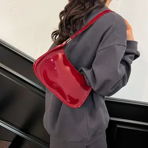 Retro deep red patent leather shoulder bag with glossy finish and minimalist design