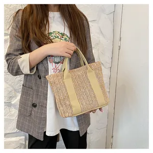 Summer woven straw beach tote with herringbone pattern and tan canvas handles