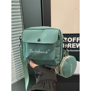 Green canvas dachshund crossbody bag with matching round coin purse pouch attachment