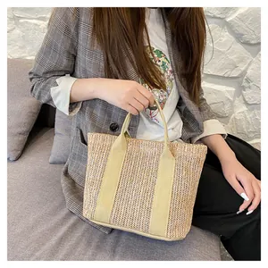 Large beige woven straw shoulder bag for summer beach travel with canvas handles