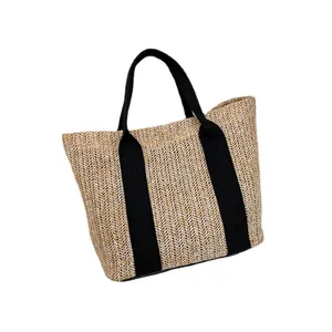Large woven straw tote bag with black fabric straps for summer beach vacation