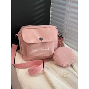 Cute pink nylon crossbody bag set with small round coin purse and white Dachshund text