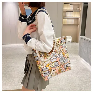Detail of canvas tote bag with cat patterns, thick rope handles and leather logo