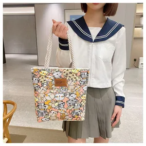 Close-up of durable canvas tote with cute cat patterns and thick cotton rope handles