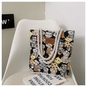 Detail of canvas tote with cute cartoon cat prints and thick cream cotton rope handles