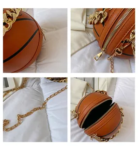 Detail view of round basketball crossbody bag with gold chain strap and dual zippers