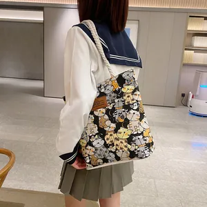 Minimalist canvas tote bag with colorful cartoon cat prints and braided rope handles