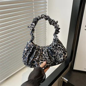 Fashionable leopard print handbag with a pleated handle and stylish crescent moon shape