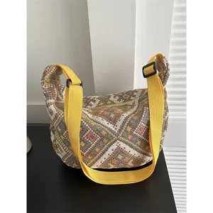 Ethnic style jacquard shoulder bag with geometric patterns and bright yellow strap
