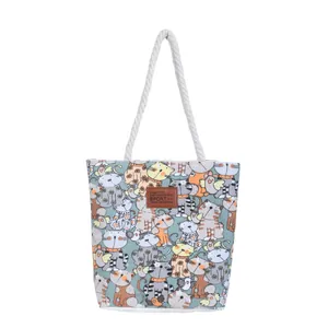 Canvas tote bag with cute cartoon cat prints and thick rope handles on white background