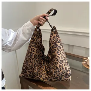 Detail of leopard print tote bag showing large capacity suede texture and bow decoration