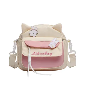 Süße Canvas-Umhängetasche mit Katzenohren und Cartoon-Anstecknadeln für Mädchen in Rosa
