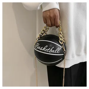Macro shot of creative basketball-shaped purse with textured black leather and gold chains