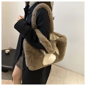 Detail of soft plush tote bag in dark brown with white heart patterns and wide handle