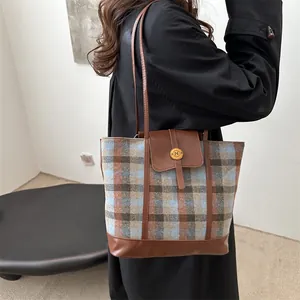 Retro plaid tweed tote bag with orange and blue stripes, featuring brown leather handles