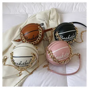 Detail of round basketball cross-body bags in brown, black, white, and pink leather textures